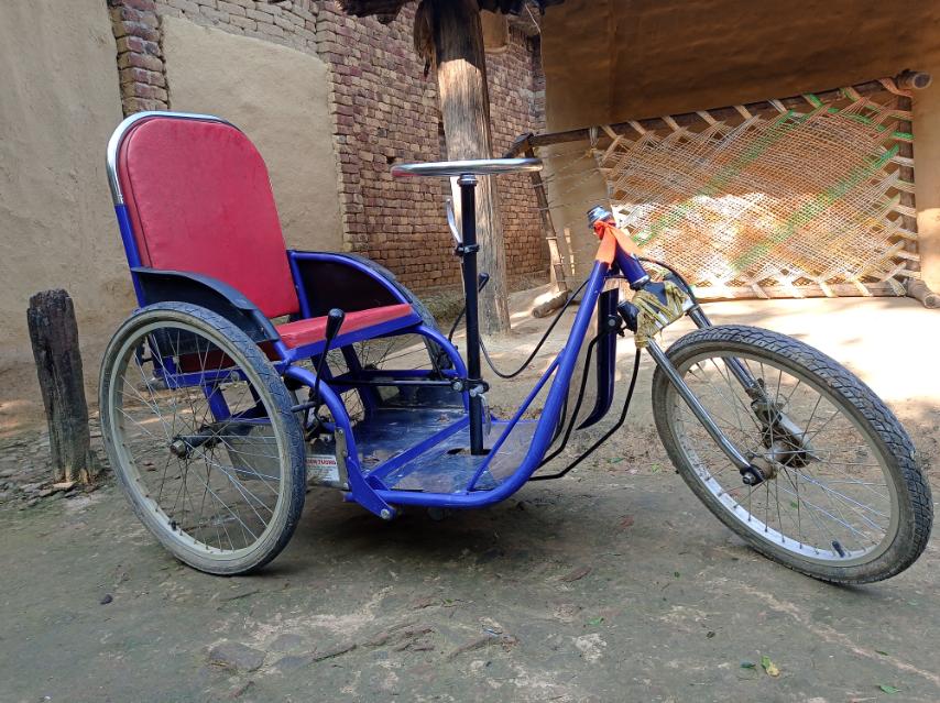 A blue tricycle wheelchair.